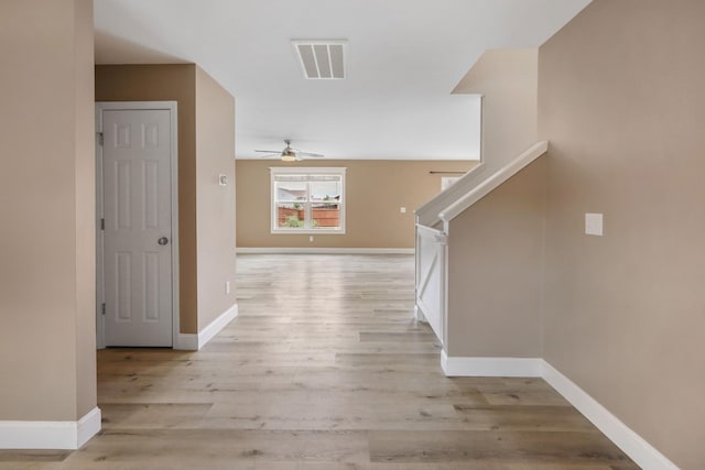 corridor with light hardwood / wood-style flooring