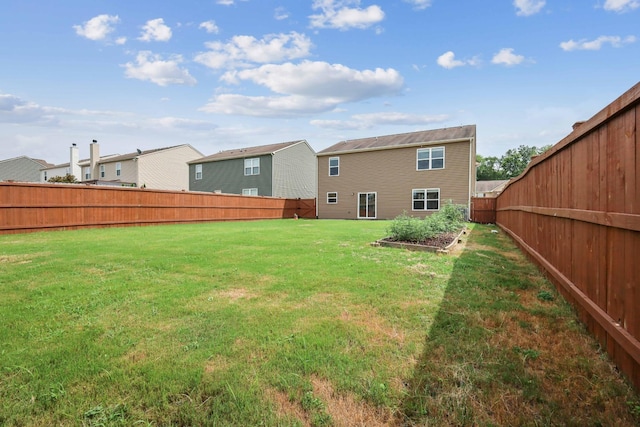 rear view of house featuring a lawn