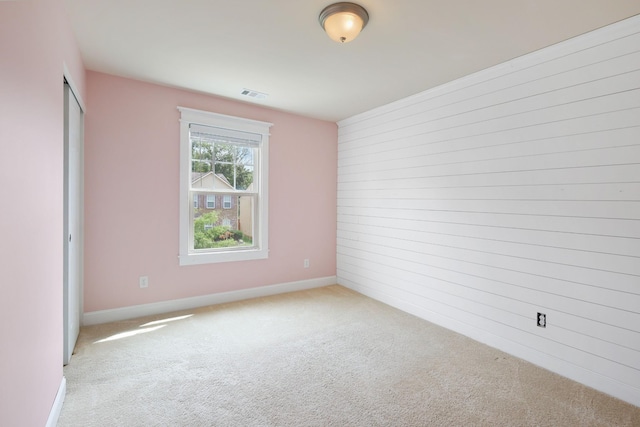 spare room featuring light colored carpet