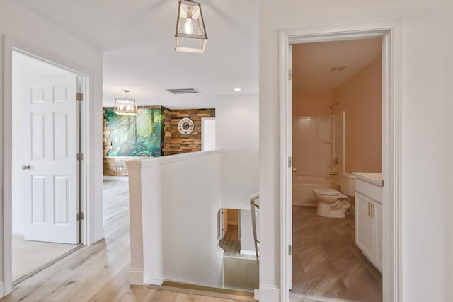 full bathroom with hardwood / wood-style flooring, vanity, shower / bathtub combination, and toilet