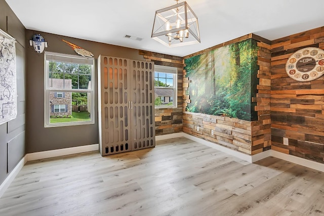 interior space featuring wood-type flooring and an inviting chandelier