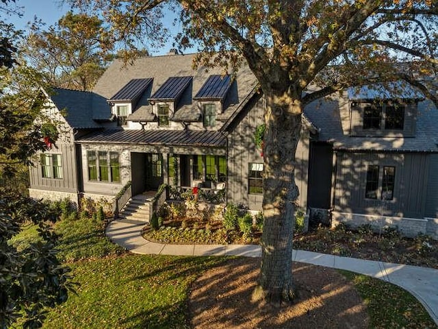 view of front of property featuring metal roof and a standing seam roof