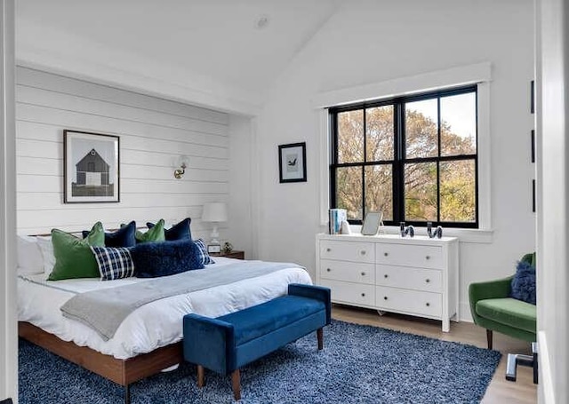 bedroom featuring hardwood / wood-style flooring and lofted ceiling