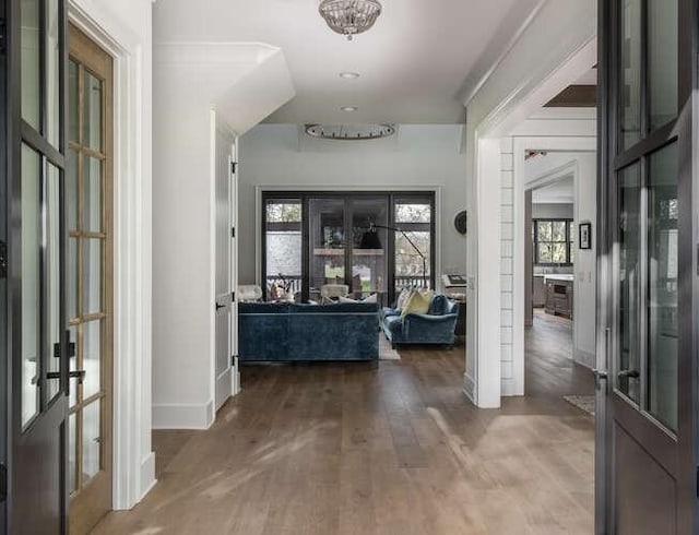 entrance foyer with baseboards, wood finished floors, and french doors