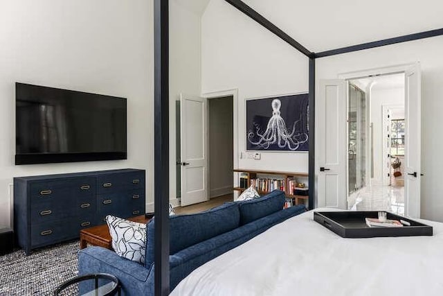 bedroom with lofted ceiling and crown molding