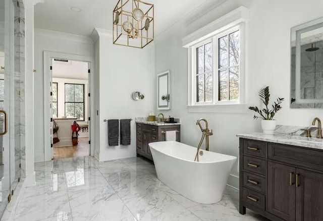 bathroom featuring a freestanding tub, vanity, marble finish floor, a stall shower, and crown molding