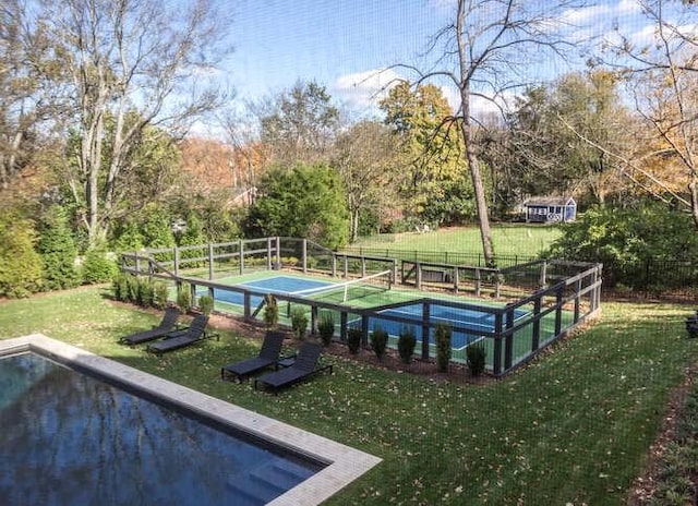 view of pool with a yard