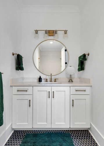 bathroom with vanity and ornamental molding