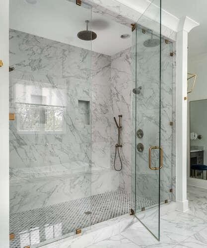 full bathroom with marble finish floor and a marble finish shower