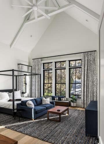 interior space featuring hardwood / wood-style flooring, ceiling fan, high vaulted ceiling, and beamed ceiling