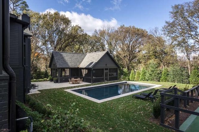 view of pool featuring an outbuilding, a yard, and a patio area