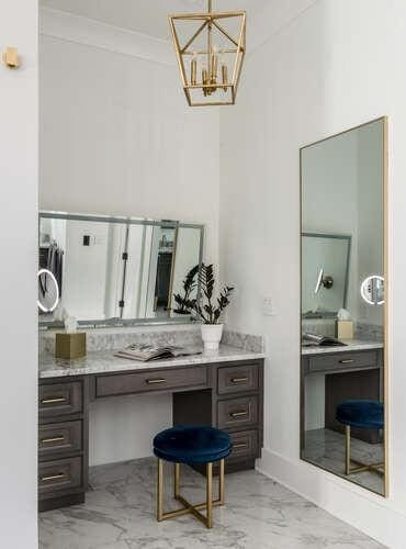 bathroom with baseboards, ornamental molding, marble finish floor, an inviting chandelier, and vanity