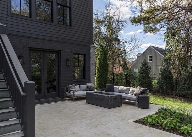 view of patio / terrace with an outdoor living space with a fire pit and french doors