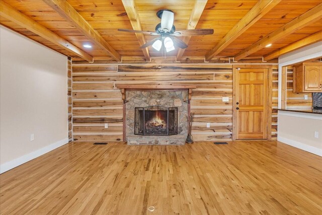 unfurnished living room featuring beamed ceiling, a fireplace, light hardwood / wood-style floors, and wooden ceiling