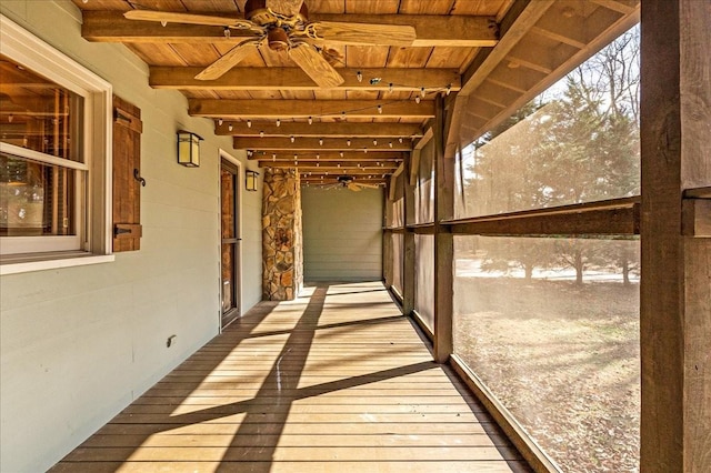 interior space with ceiling fan, wooden ceiling, and beamed ceiling