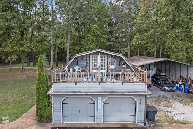 back of house featuring a carport, a yard, a deck, and a garage