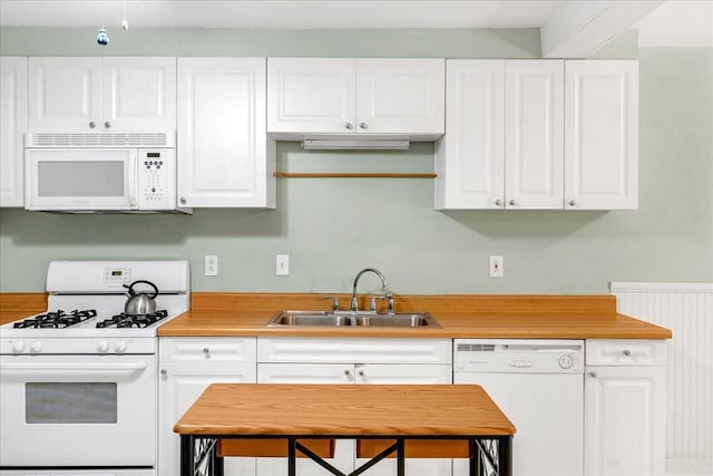 kitchen featuring white cabinetry, white appliances, and sink