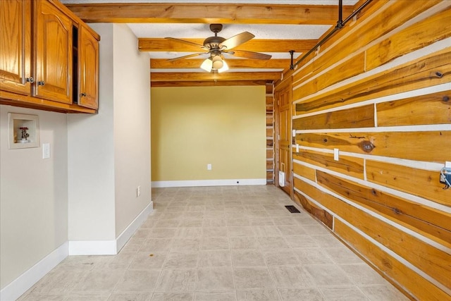 spare room featuring ceiling fan and beam ceiling