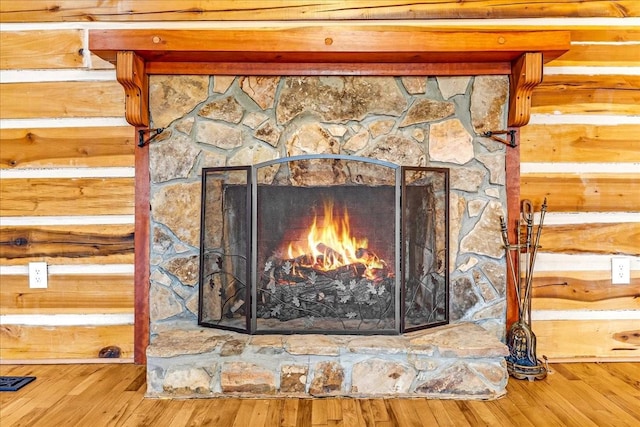 details with a stone fireplace and hardwood / wood-style floors