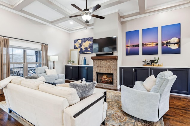 living room featuring dark hardwood / wood-style floors, a fireplace, coffered ceiling, and beamed ceiling