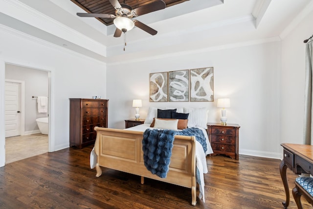 bedroom with dark hardwood / wood-style flooring, ornamental molding, ceiling fan, a raised ceiling, and ensuite bath