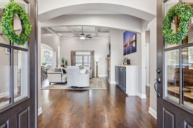 foyer featuring dark hardwood / wood-style floors, coffered ceiling, ceiling fan, bar area, and beam ceiling