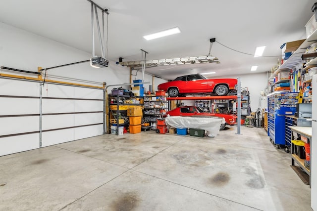 garage featuring a garage door opener and a workshop area