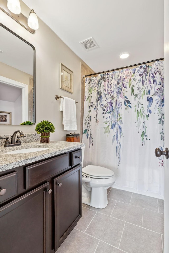 bathroom featuring vanity, curtained shower, and toilet