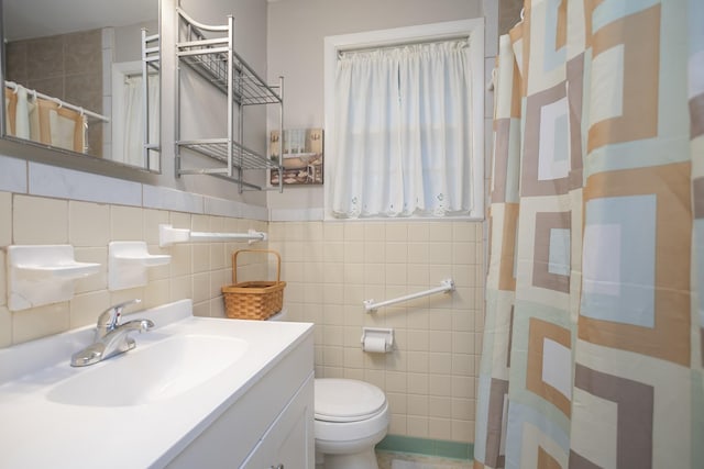 full bath featuring curtained shower, tile walls, toilet, and vanity