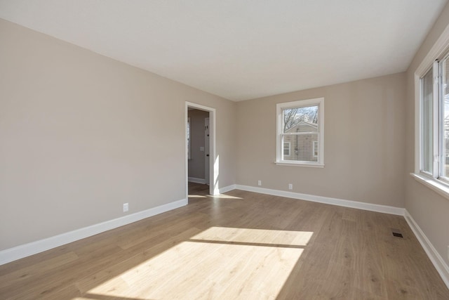 unfurnished room with hardwood / wood-style flooring