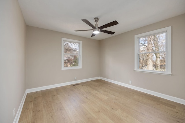 spare room with ceiling fan and light wood-type flooring