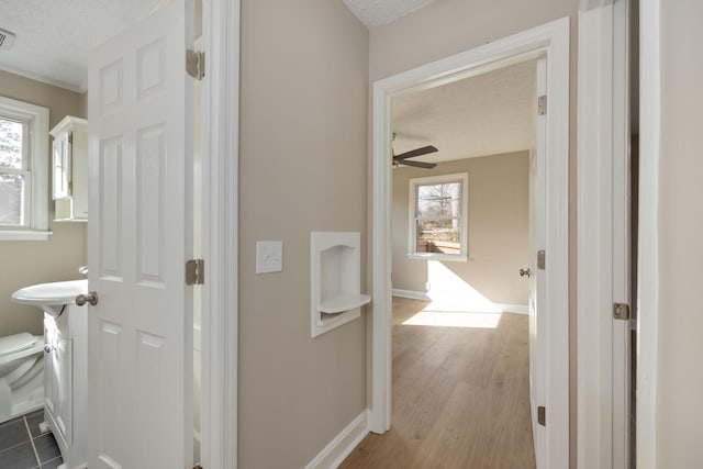 hall featuring hardwood / wood-style flooring and a textured ceiling