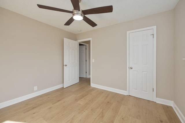 unfurnished bedroom with ceiling fan, a textured ceiling, and light hardwood / wood-style floors