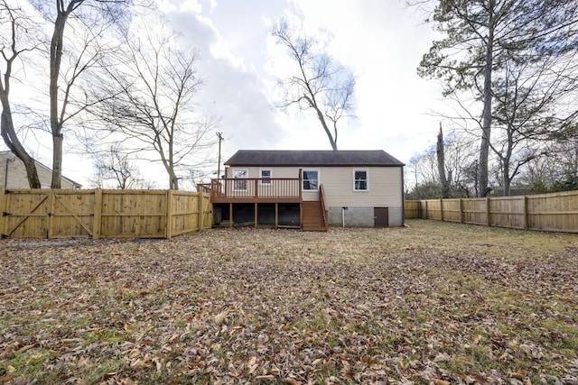 rear view of property featuring a wooden deck