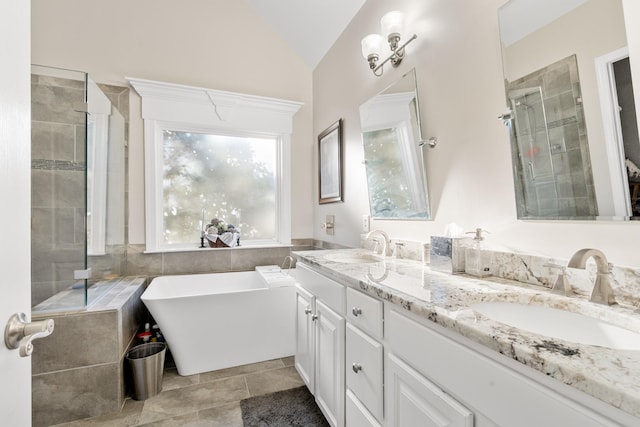 bathroom with tile patterned floors, lofted ceiling, plus walk in shower, and vanity