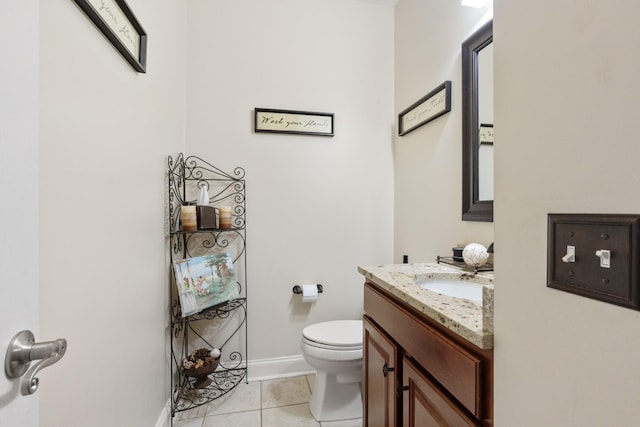 bathroom with tile patterned flooring, vanity, and toilet