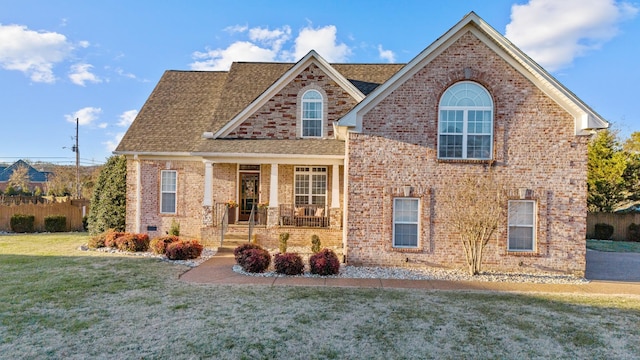 view of front of home with a porch and a front lawn