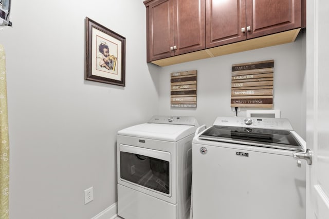 laundry area with cabinets and washer and clothes dryer