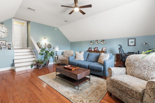 living room featuring lofted ceiling, hardwood / wood-style flooring, and ceiling fan