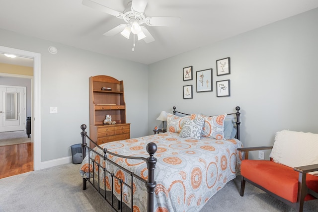 bedroom featuring light carpet and ceiling fan