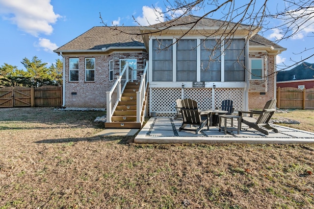 back of property with a yard and a patio area