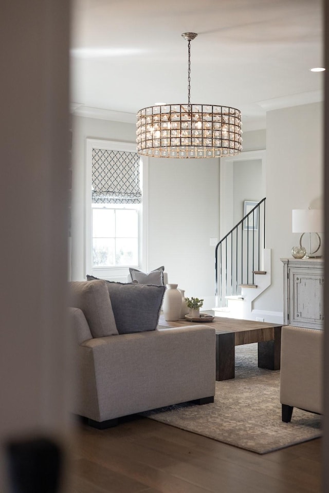 living room featuring hardwood / wood-style flooring and crown molding