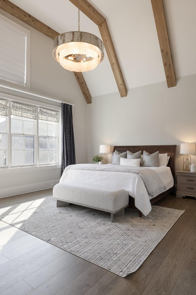 bedroom with hardwood / wood-style flooring, beam ceiling, and high vaulted ceiling