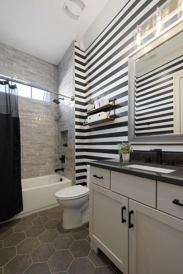 full bathroom with tile patterned flooring, vanity, shower / bathtub combination with curtain, and toilet