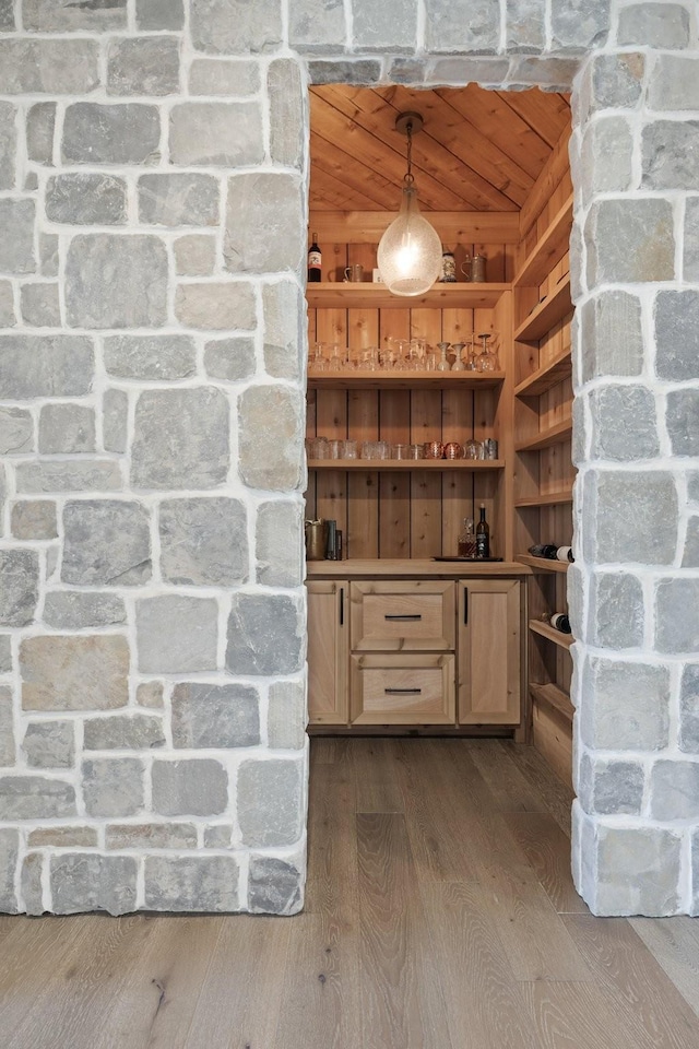 kitchen with hanging light fixtures, wood-type flooring, and wooden ceiling