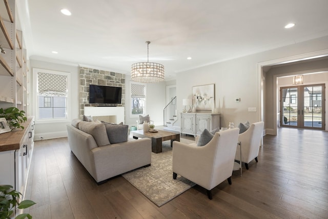 living room with crown molding, dark hardwood / wood-style floors, and french doors