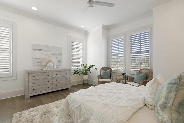 bedroom with dark hardwood / wood-style flooring, ornamental molding, and ceiling fan