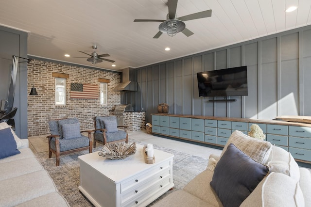 living room with brick wall, wooden ceiling, and ceiling fan