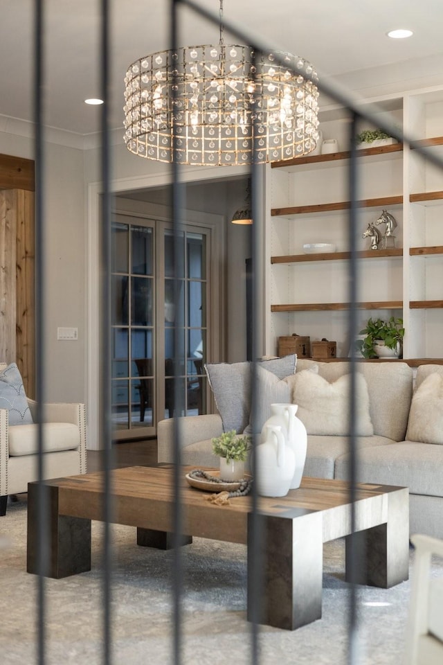 unfurnished living room with crown molding and a chandelier