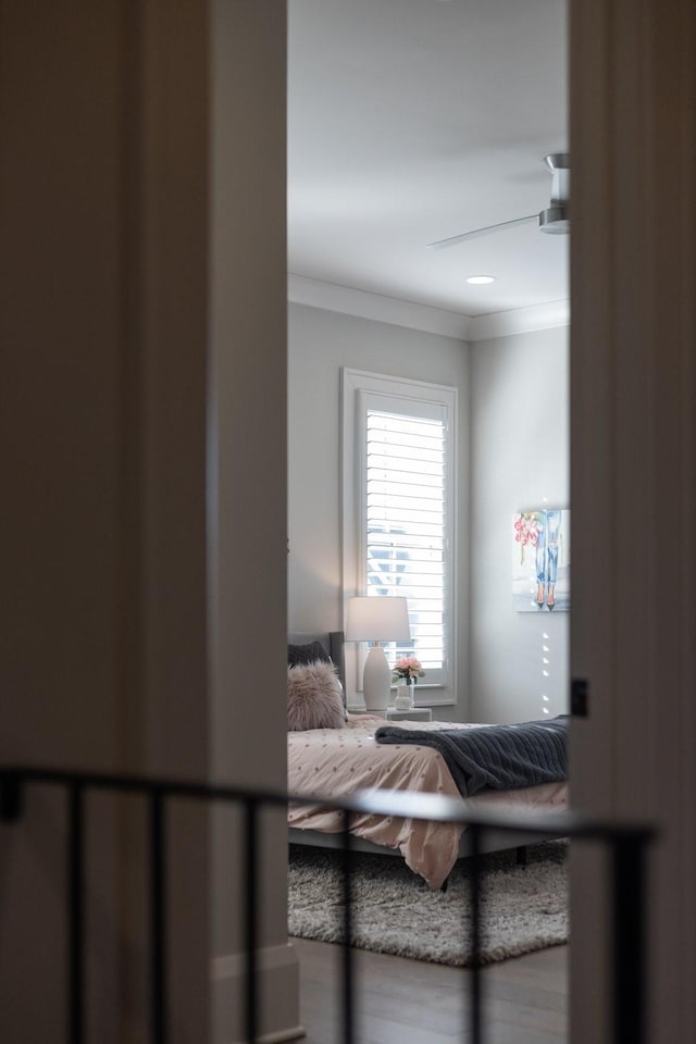 bedroom featuring ornamental molding and ceiling fan